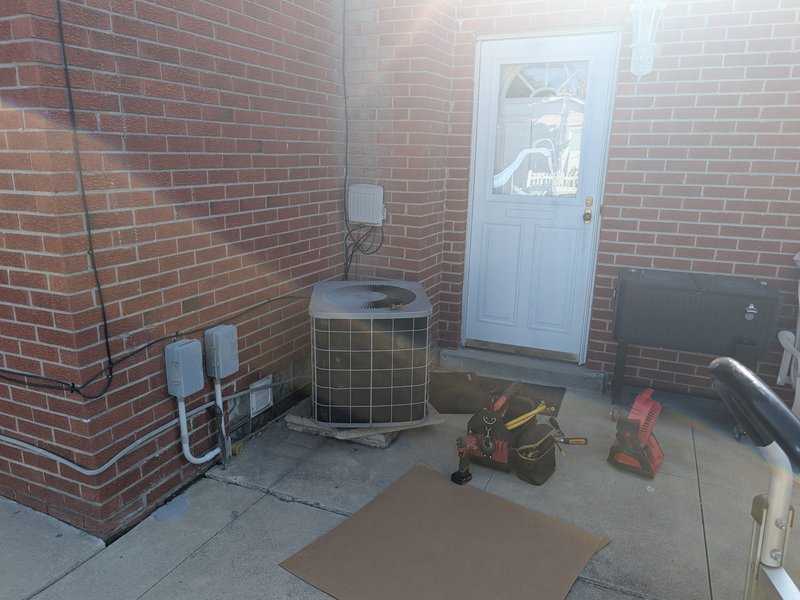 Air conditioner maintenance visit by Americool Heating and Cooling in Downriver Michigan