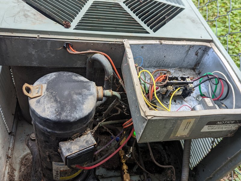 Air conditioner repair on an outdoor condenser by Americool Heating and Cooling